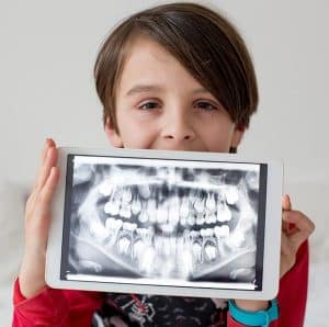 dental technology kid holding his digital xray