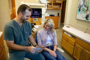Dentist discussing IV sedation options with a patient in a dental office, emphasizing comfort and care at Lexington Dental of Owasso.