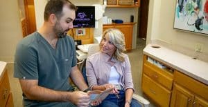Dentist discussing treatment options with a patient in a dental office, showcasing personalized care at Lexington Dental of Owasso.