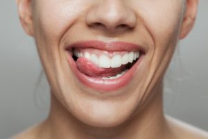 close up image of woman's mouth with tongue out