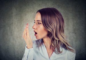 woman checking for bad breath