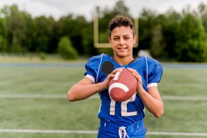 young boy with american football
