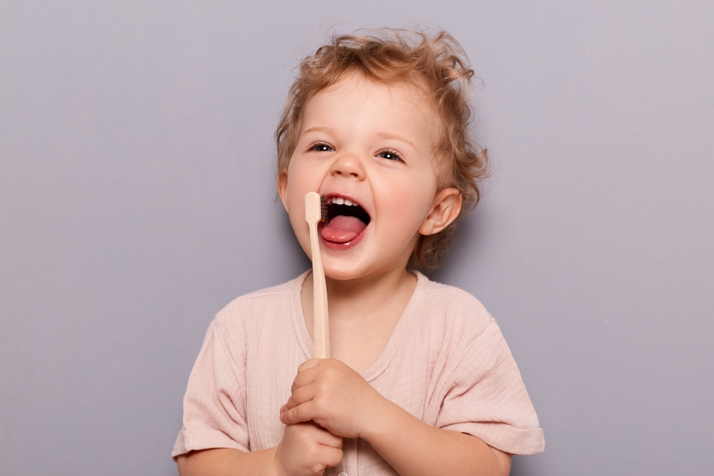 toddler with toothbrush