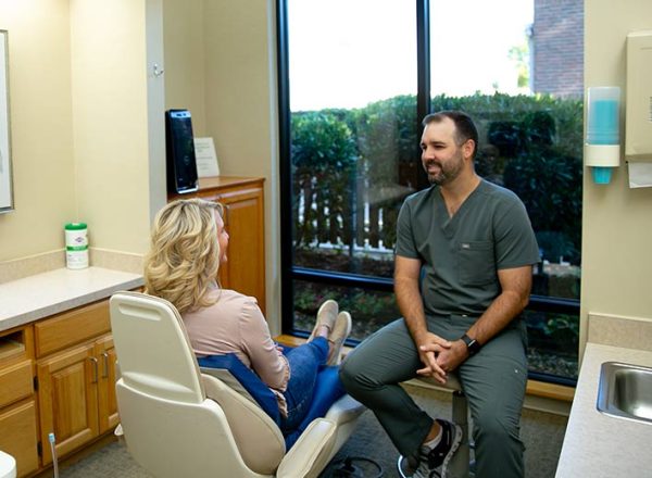 dr-cary-with-patient dr cary explaining dental care in owasso to a patient
