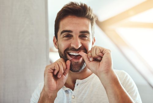 man flossing